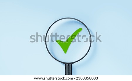 magnifying glass focuses on green tick. Check mark, Check Mark Sign, Tick Icon, right sign, green checkmark button, Done. On blue background. Banner. Copy space Royalty-Free Stock Photo #2380858083