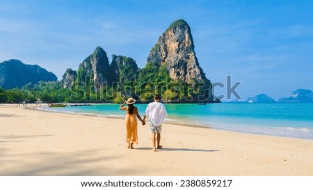 Railay Beach Krabi Thailand, the tropical beach of Railay Krabi, a couple of men and women walking on the beach, idyllic Railay Beach in Thailand. Couple on vacation holiday in Thailand Royalty-Free Stock Photo #2380859217