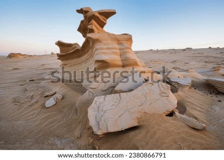 Desert eroded rock pattern with clear sky during the sunset. Desert rock formation with erosion. Royalty-Free Stock Photo #2380866791