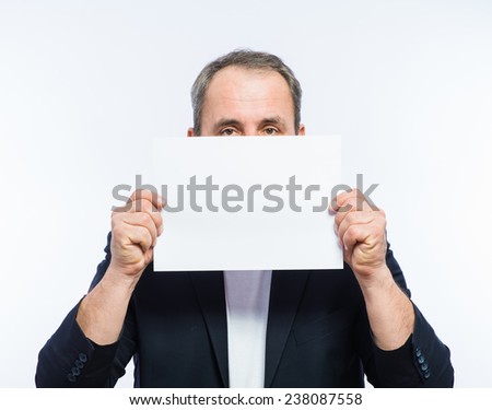 Businessman showing the big blank card in hand