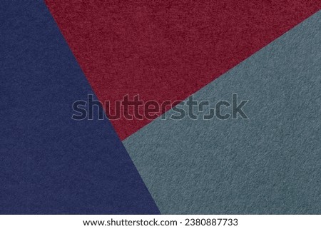 Texture of craft navy blue, wine and cold gray shade color paper background, macro. Structure of vintage abstract cardboard with geometric shape and gradient. Felt backdrop closeup.