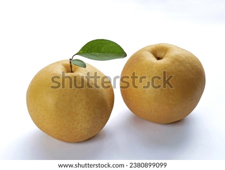 Close up of two yellow pear fruits with leaf on white floor, South Korea

