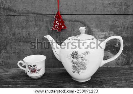 White teapot and cup with red christmas tree