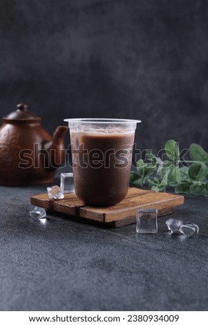 Iced cocoa or iced chocolate drink in a plastic glass