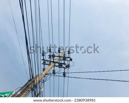 electric pole in a minimalist composition on a bright blue sky with empty space to enter text