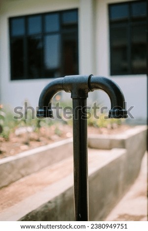 The T-shaped septic tank gas discharge pipe curves downwards so that water does not enter Royalty-Free Stock Photo #2380949751