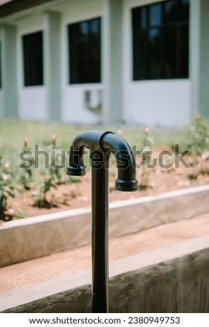 The T-shaped septic tank gas discharge pipe curves downwards so that water does not enter Royalty-Free Stock Photo #2380949753