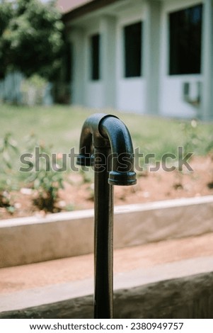 The T-shaped septic tank gas discharge pipe curves downwards so that water does not enter Royalty-Free Stock Photo #2380949757