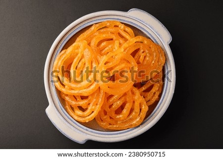 Top View of jalebi Indian sweet dish isolated on black background Royalty-Free Stock Photo #2380950715