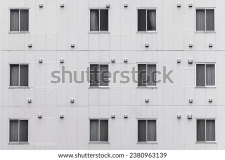 picture of a facade of a building with rows of windows in Japan