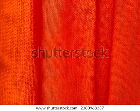 The background of the orange bus curtains covers the sunlight from behind the window