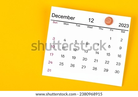 December 2023 and wooden push pin on yellow background. Royalty-Free Stock Photo #2380968915