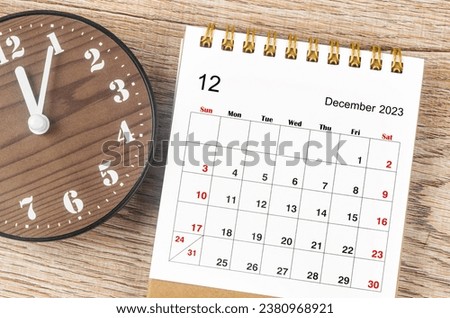 December 2023 Monthly desk calendar for 2023 year with wooden clock. Royalty-Free Stock Photo #2380968921