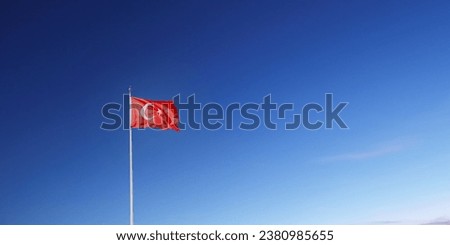Turk Bayragi - Turkish Flag waving in the beautiful cloudless blue sky. Background photo for Turkish national days greeting message and social media message