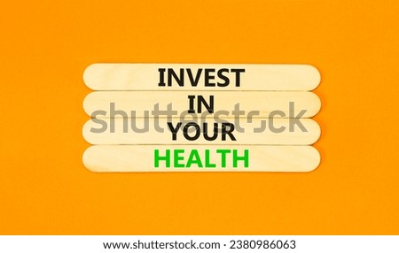 Invest in your health symbol. Concept word Invest in your health on beautiful wooden stick. Beautiful orange table orange background. Invest in your health concept. Copy space.