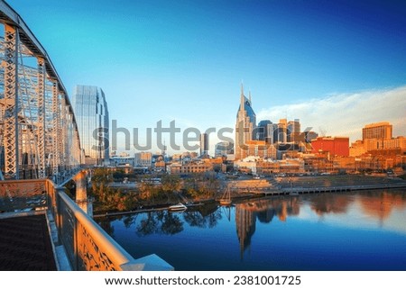 Nashville, Tennessee downtown skyline with Cumberland River in USA at sunset Royalty-Free Stock Photo #2381001725