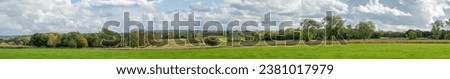 Wide panorama of beautiful Cotswold landscape on a sunny autumn day with  a long vista. and cloudscape English countryside Royalty-Free Stock Photo #2381017979