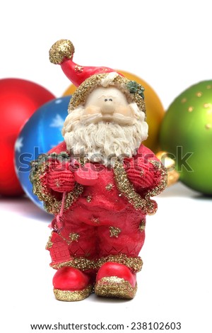 small ceramic Santa Claus on a background of Christmas toys