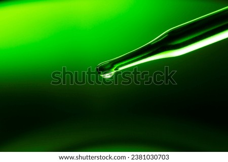 Macro green science experiment background,Lab glassware filled with clear transparent liquids on reflective surface against green background | Abstract science experiment concept