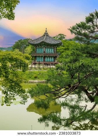 Sunset at the Hyangwonjeong Pavilion in the center of the pond in the Gyeongbokgung palace, Seoul, South Korea. Royalty-Free Stock Photo #2381033873