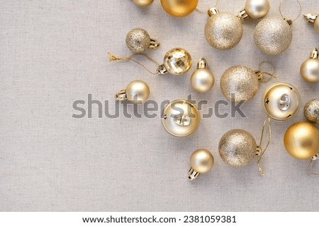 Aesthetic luxury Christmas, New Year festive background with copy space. Gold pastel ornaments, decoration balls pattern on neutral beige backdrop. Elegant minimalist business brand template, banner.