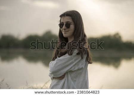 Young business woman having a job interview on the phone, doing business analysis, in the garden of the office, by the lake Royalty-Free Stock Photo #2381064823