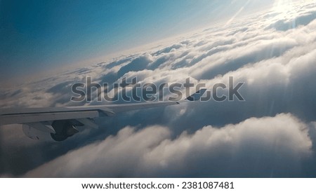 Flight Over Clouds in much altitude by Airbus a340 Royalty-Free Stock Photo #2381087481