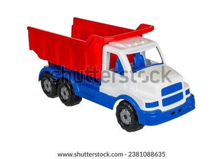 Children's toy plastic big dump truck with a folding body isolated on a white background close-up