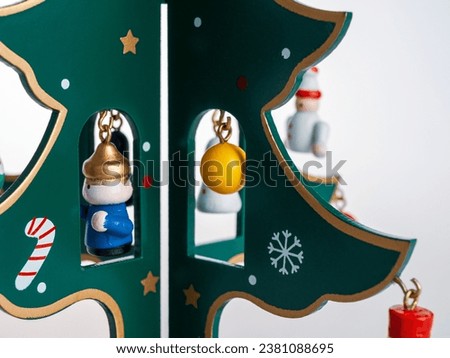 Christmas tree toy with toys on branches, New Year decoration isolated on white background close-up
