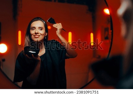 
Woman Dying Her Hair at Home Looking in the Mirror. Modern girl applying hair dye by herself trying to change her looks
 Royalty-Free Stock Photo #2381091751
