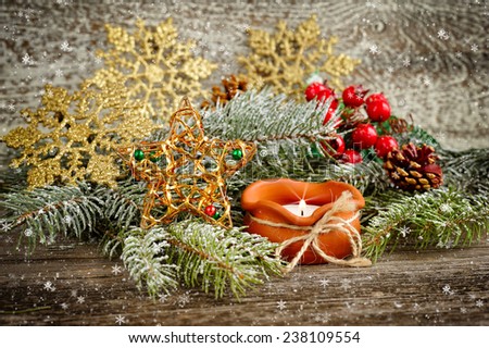 Christmas composition is with candle on wooden background