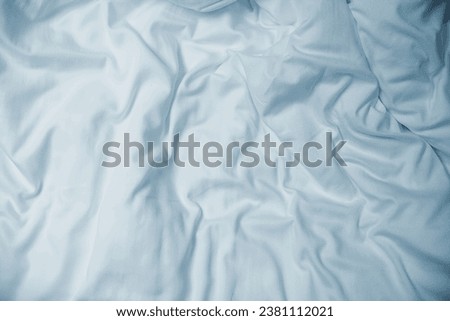 Top view of the folds of an unmade bed sheet in the bedroom after a long night's sleep.
 Royalty-Free Stock Photo #2381112021