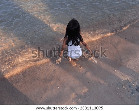 girls are playing on the beach in the morning