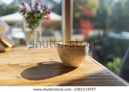 White Coffee cup on wooden table in cafe with lighting background