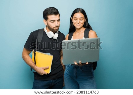 Smart university students and couple using the laptop and doing homework together while going to college  Royalty-Free Stock Photo #2381114763