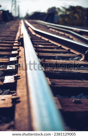 Picture of railway tracks with houses and power poles in the background 