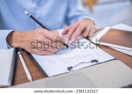 Closeup professional businessman hand pen writing work document strategy on tablet technology indoor workplace office table, adult entrepreneur business man manager person note finance report notepad