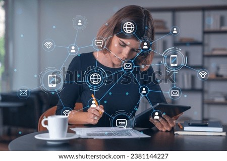 Businesswoman holding tablet device, touching screen. Office workplace. Concept of digital network, Social net connection front hologram, distant work, business education, information technology. Royalty-Free Stock Photo #2381144227