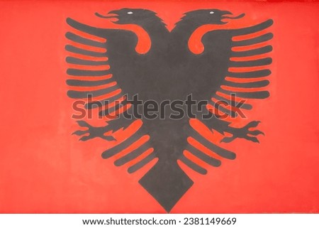 Close up of flag of Albania painted on the wall. Concept of Albania. Flag of Albania. Albanian symbol. Nobody, street photo, copy space for text