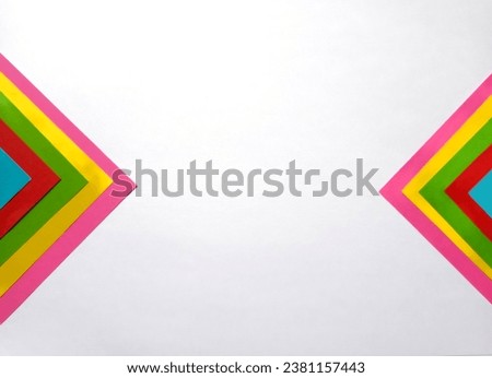 multicolored geometric pieces of paper on a white background