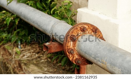 Rust corrosion flange and bolt on the old steel water pipeline distribution.Grunge rusted metal texture. Rusty corrosion and oxidized background. Royalty-Free Stock Photo #2381162935