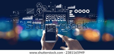 Sponsor theme with person using a smartphone in a city at night Royalty-Free Stock Photo #2381165949