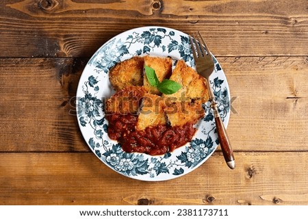 Basil cheese cutlet with tomato sauce