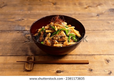 bowl of rice topped with Chinese stir-fry containing green pepper paste