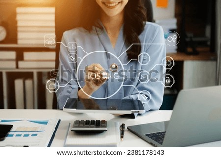 Web hosting concept, business using computer and presses his finger on the virtual screen inscription Hosting on desk, Internet, business, Technology and network concept. Royalty-Free Stock Photo #2381178143