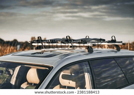 Versatile Roof Rack for Station Wagons: Safely Transporting Sports Equipment and Big Items. A roof rack or bar on a station wagon or estate car. Transportation of sports equipment in the family car. Royalty-Free Stock Photo #2381188413