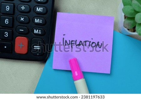 Concept of Inflation write on sticky notes isolated on Wooden Table.