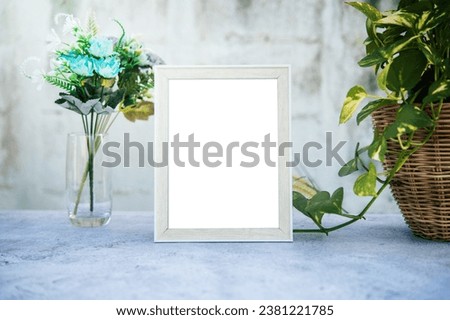 The picture frame is placed on the cement table.