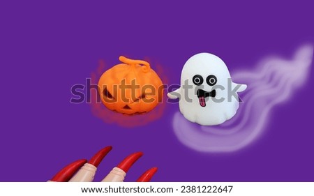 Sharp red witch's nails Little ghost floating with white smoke Orange devil pumpkin spits fire in Halloween festival, purple background


