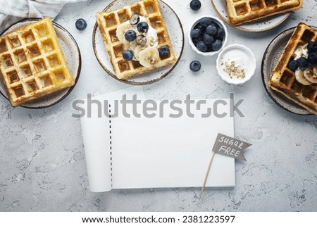 Top view waffles with fruits arrangement Royalty-Free Stock Photo #2381223597